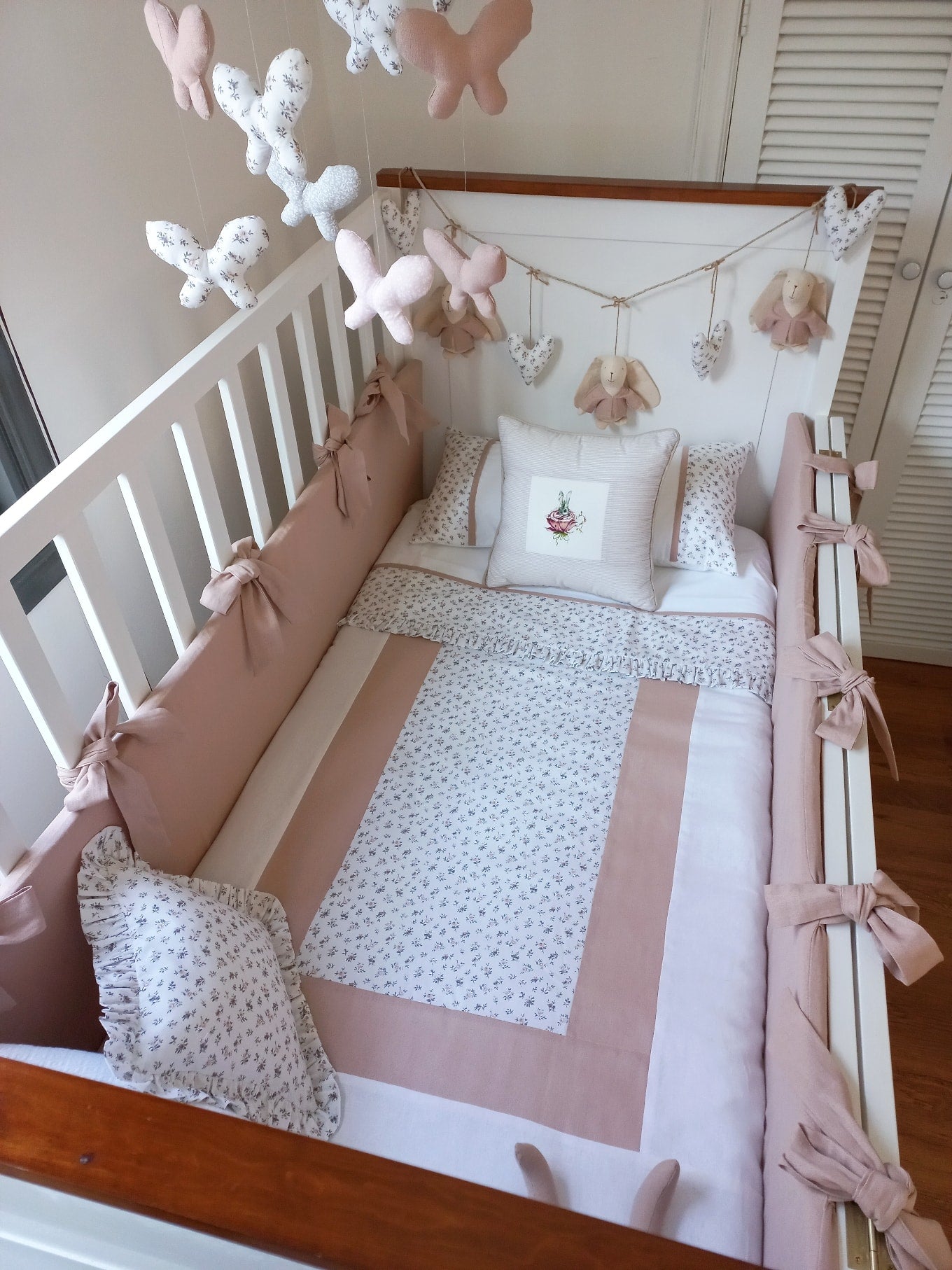 Ropa de cama blanca y rosa telas patchwork en mesa en tonos